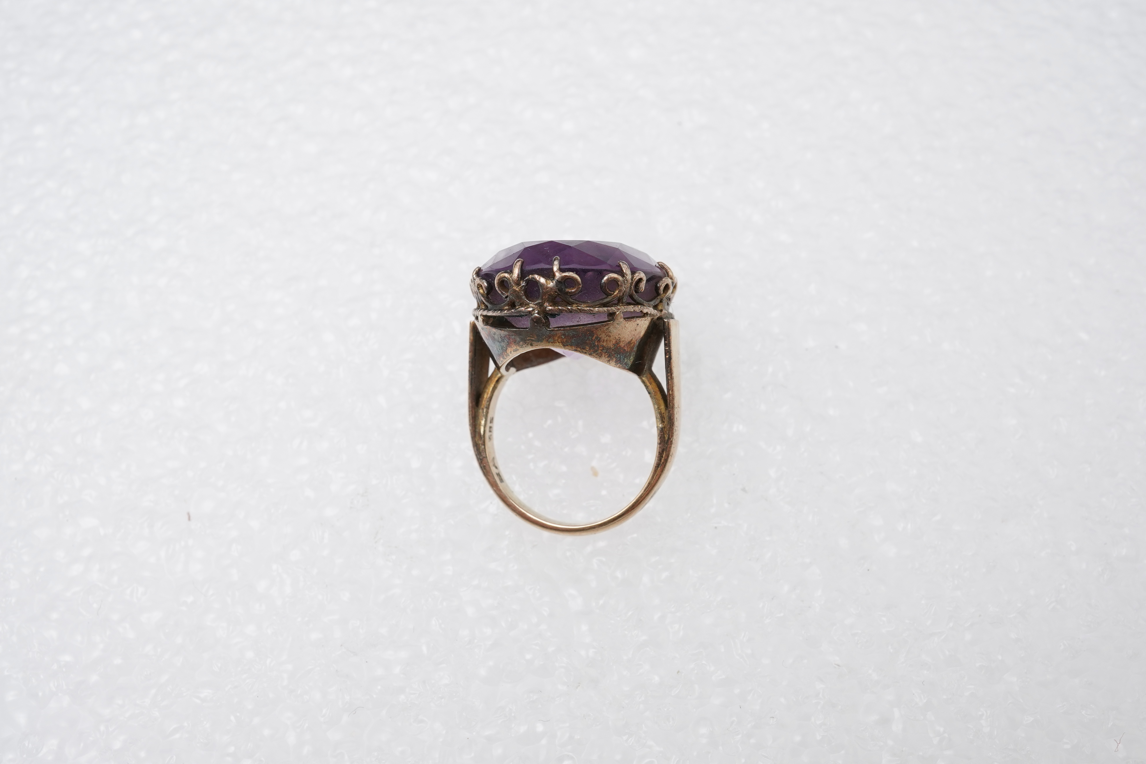 An amethyst ring, necklace and pendant, comprising: an oval amethyst set in a floral gilt silver necklace, length 32cm; an oval amethyst and seed pearl pendant, length 3.7cm; and a ring set with an oval amethyst, mounted